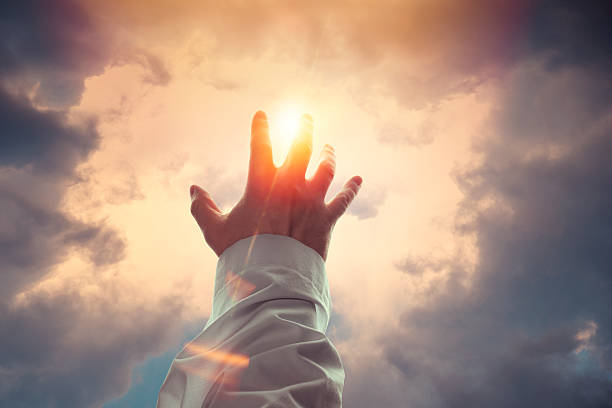 hand reaching toward the light