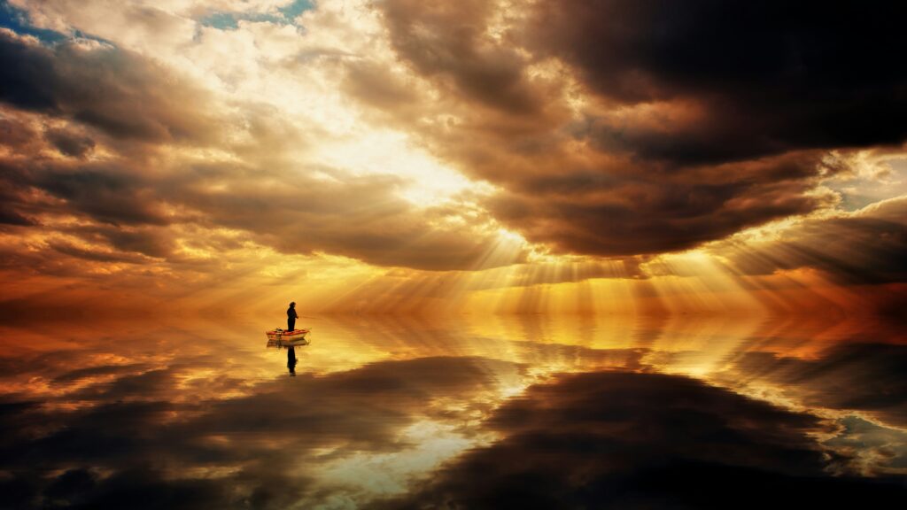 near-death experience light rays breaking through clouds over still water